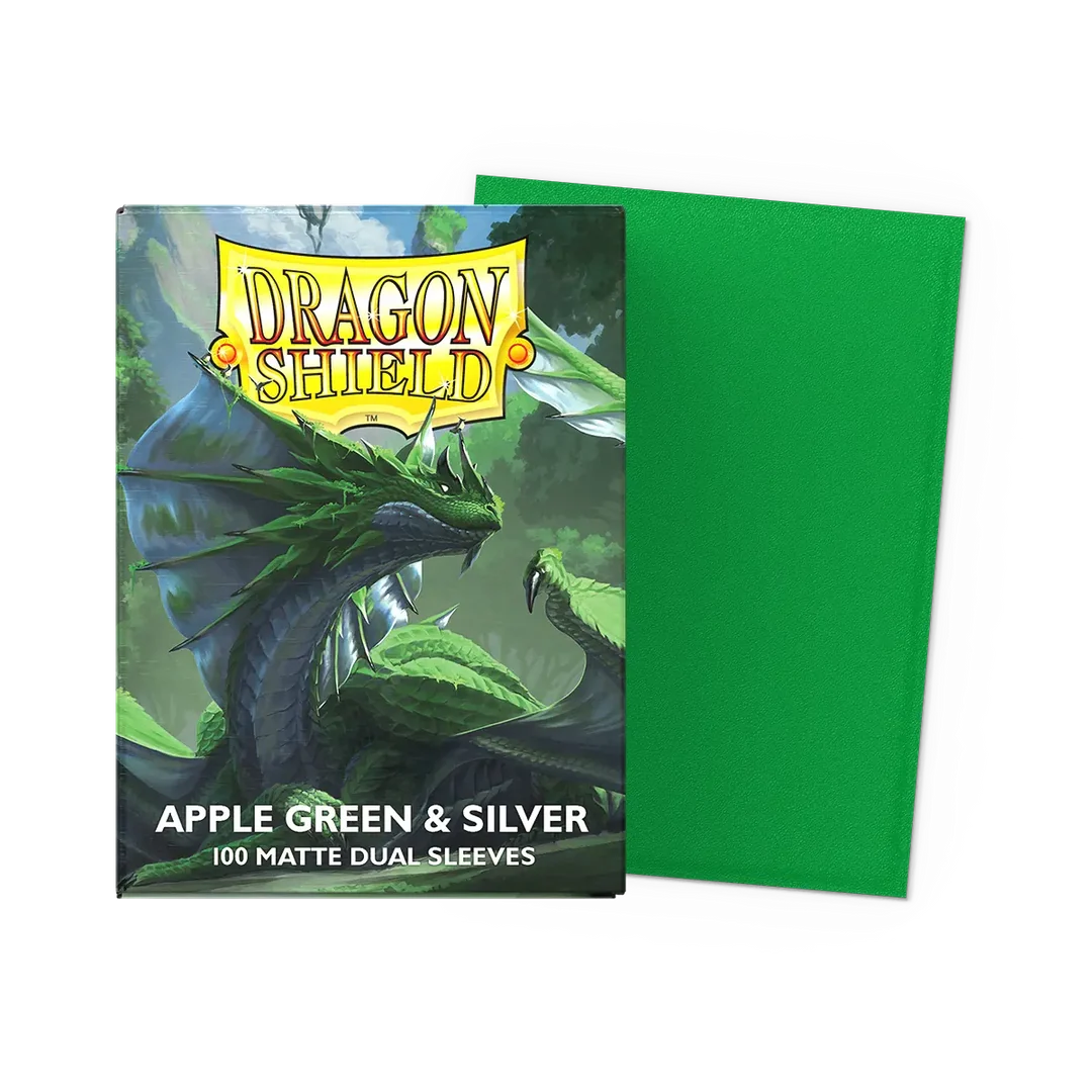 A box of Dragon Shield: Matte Dual Sleeves - 100 stk. featuring a green dragon illustration, next to a single solid green sleeve.