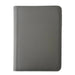A closed TCGPicks: Samlekortmappe [360 pockets 3X3] by Ml Trading, featuring a gray textured cover with visible stitching and rounded corners, is placed on a white surface.