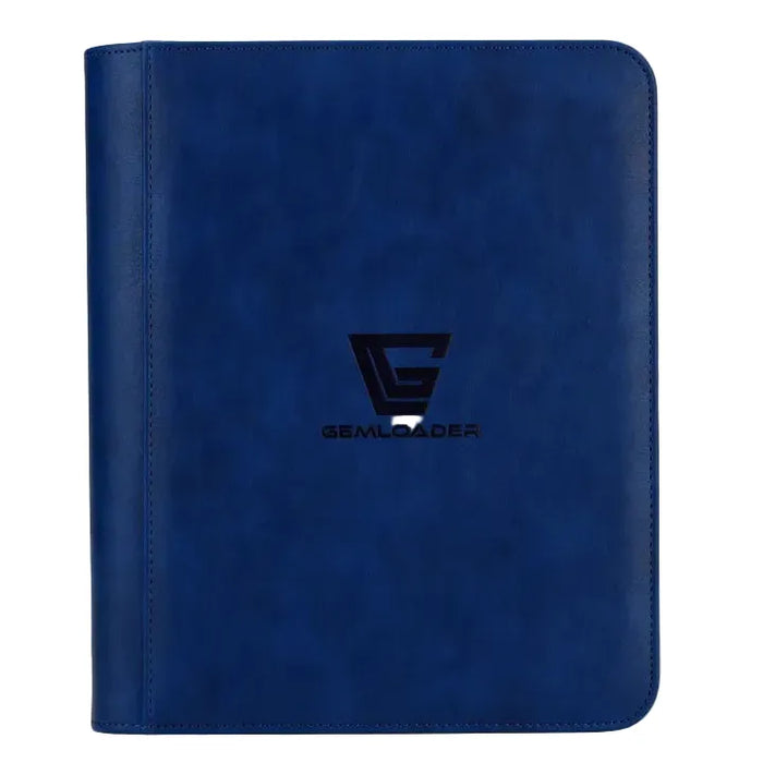 The Gemloader: Premium Toploader Mappe [112 pockets 2X2] by Gemloader is a blue leather binder with rounded edges, displaying a black G logo and the word GEMLOADER on the front cover. Standing upright against a plain background, this premium collector’s mappe is the ideal tilbehør til samlekort, expertly designed to keep your collection organized and protected.