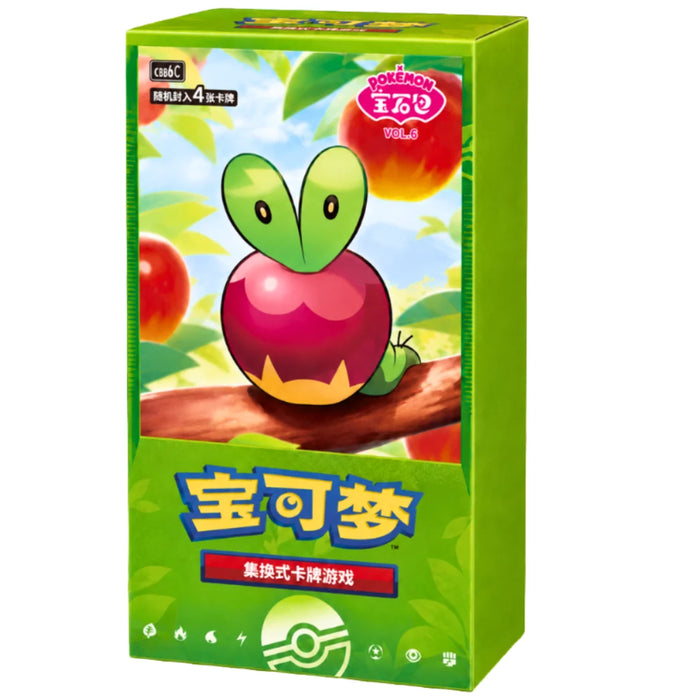 A green Pokémon TCG: Gem Pack Vol. 6 Booster Box (Kinesisk) from the Pokémon Company, decorated with a cartoon apple and worm character, the Pokémon logo, and Chinese text on the front, displayed against a background of apples and leaves.