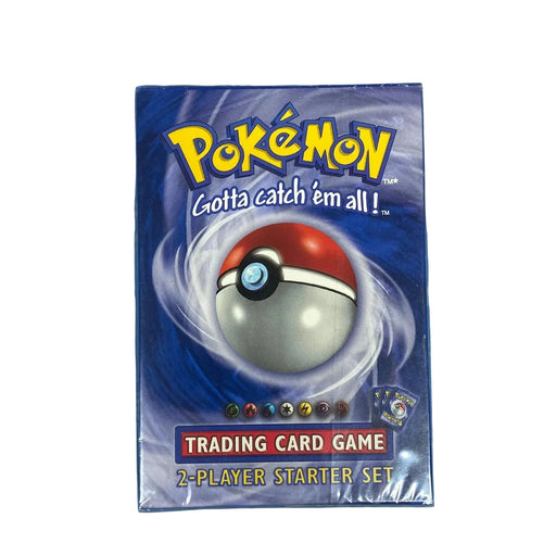A sealed Pokémon TCG: WOTC Base Set 2-Player Starter Set box from The Pokémon Company rests on a blue surface, showcasing a prominent Poké Ball and the classic slogan "Gotta catch 'em all!" on the front. This renowned starter set includes a guaranteed holofoil Machamp card, making it highly sought after by collectors and fans.