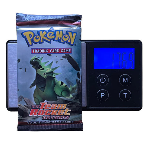 A Pokémon TCG: EX Team Rocket Returns Booster Pack - Heavy (EX Ruby & Sapphire) by The Pokémon Company sits on a digital scale at 17.69g—could it contain a Torchic Gold Star?.
