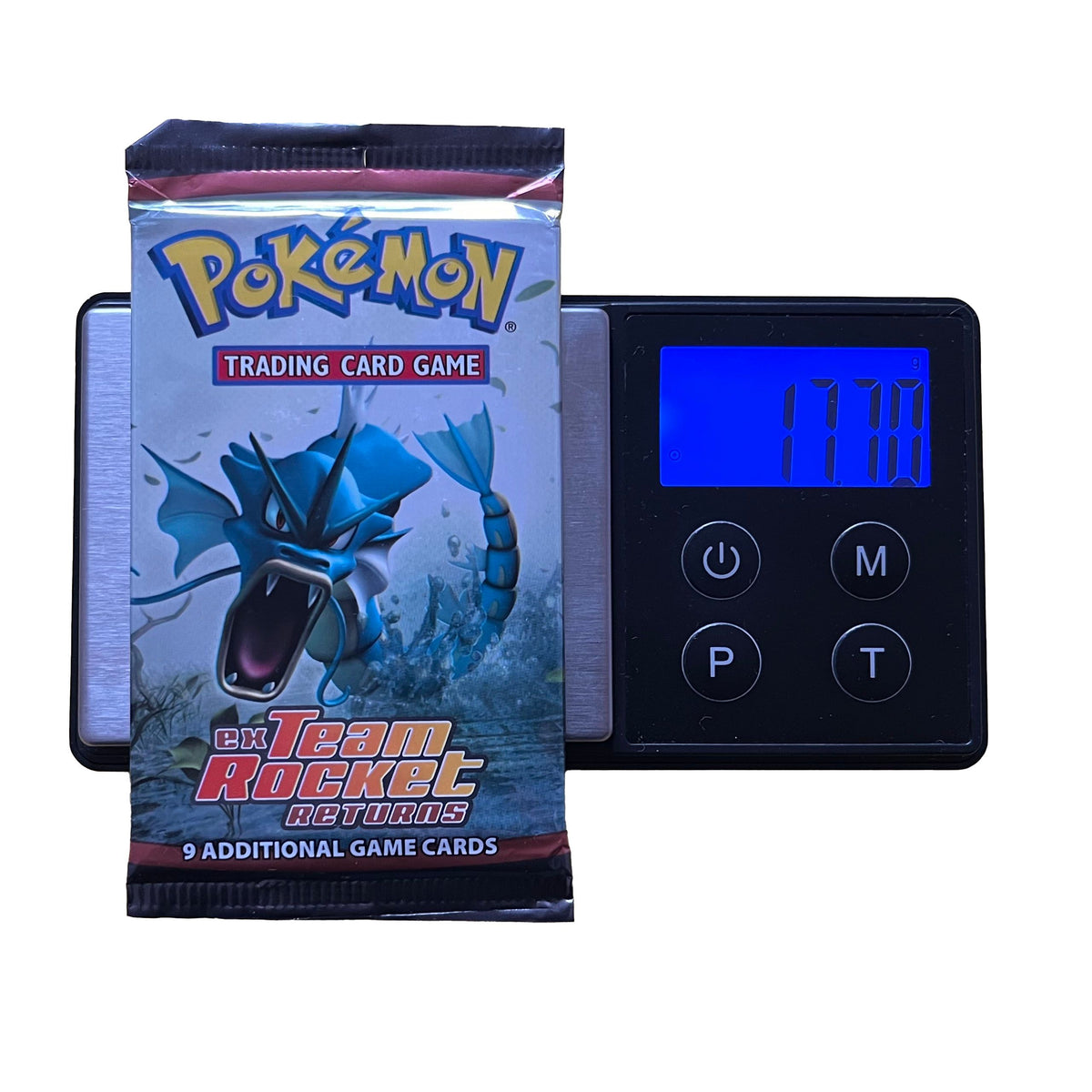 A Pokémon TCG: EX Team Rocket Returns Booster Pack - Heavy (EX Ruby & Sapphire) by The Pokémon Company, with Gyarados art, rests on a digital scale at 17.70g, offering 9 cards and a chance at rare holo or Gold Star cards.