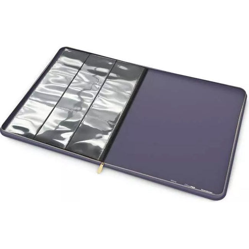 A Disney Lorcana Premium Lorebook by Ravensburger is open, displaying clear plastic sheet protectors on the left and a dark blank page on the right. The binder is empty and ready to organize your documents or trading cards.