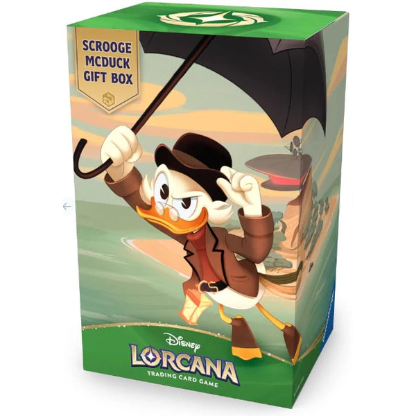 Ravensburger’s Disney Lorcana: Scrooge McDuck Gift Set features eye-catching artwork of Scrooge McDuck confidently standing atop a pile of gold coins, holding his iconic umbrella and cane. The packaging displays the set name: “Scrooge McDuck Gift Set.”.