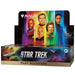 A Wizards of the Coast Magic: The Gathering – Star Trek Play Booster Display from the Universes Beyond series, showcasing portraits of iconic Star Trek characters set against a vibrant backdrop with a starship and planets below.