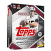 The Topps NFL Flagship Football 2026 Mega Box showcases an NFL quarterback in a white jersey and helmet, holding a football, on packaging with maroon and white design elements featuring NFL and NFLPA logos.